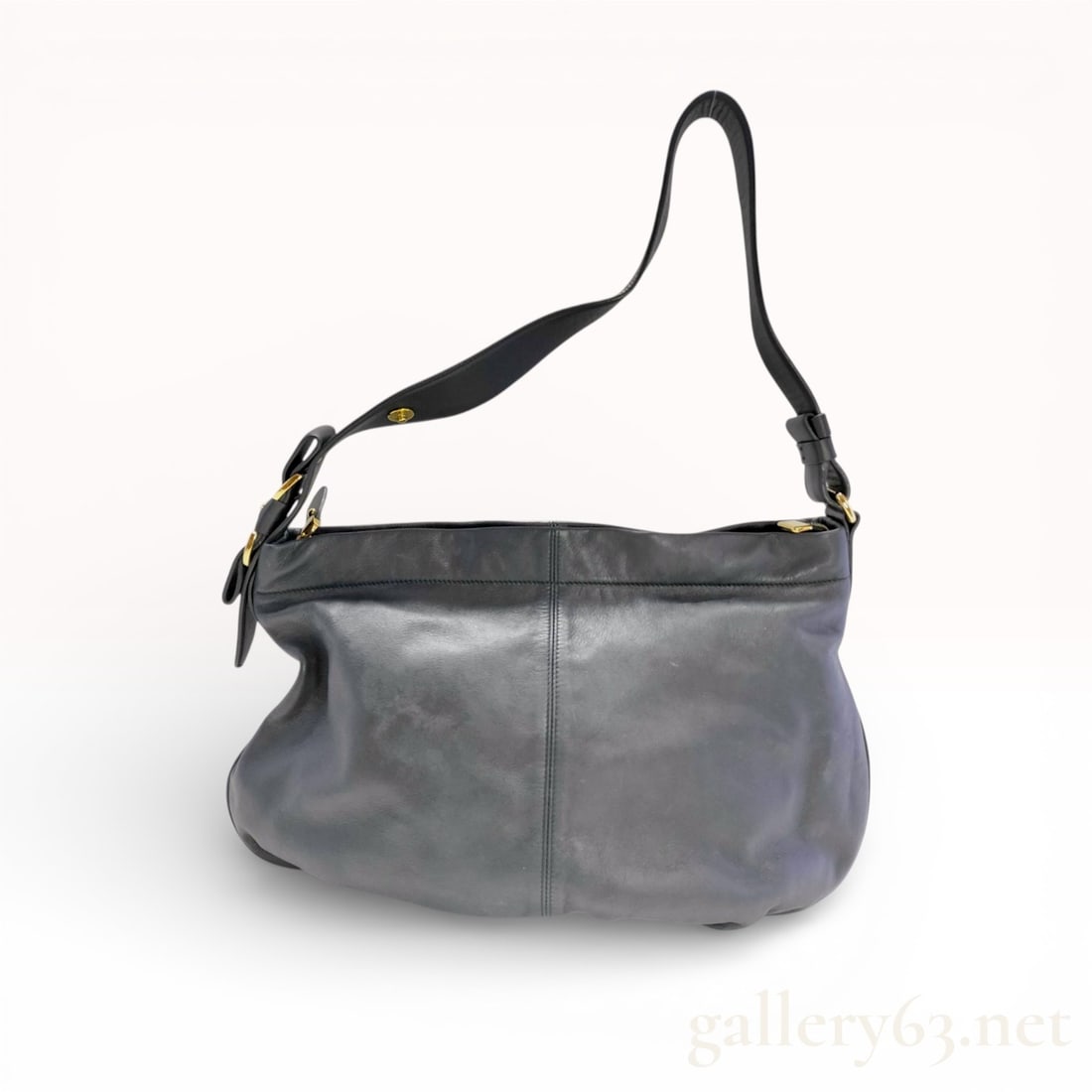 Salvatore Ferragamo Large Slouchy Hobo Shoulder Bag in Black Grained Leather: This Salvatore Ferragamo hobo-style shoulder bag is crafted from soft, black grained calfskin leather. The exterior features a vertical center seam on the front and back panels, complemented by an adj