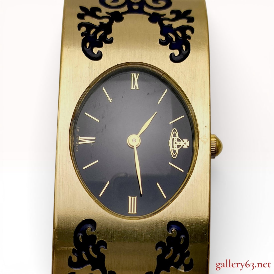Vivienne Westwood VW-9809 Gold-Tone Ornament Bangle Watch: This Vivienne Westwood ladies fashion watch, model VW-9809, features a Swiss quartz movement produced by Fortune Swiss. The gold-tone metal case is integrated into a hinged cuff bangle decorated with