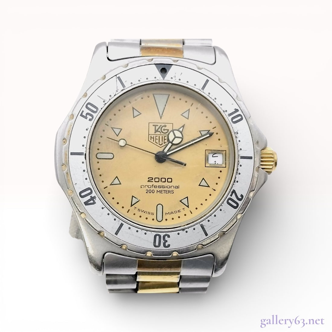 TAG Heuer 2000 Professional Reference 974.006: TAG Heuer 2000 Professional 200 Meters, reference number 974.006. Features a quartz movement. The case is constructed of stainless steel with a unidirectional rotating bezel and gold-tone accents. The