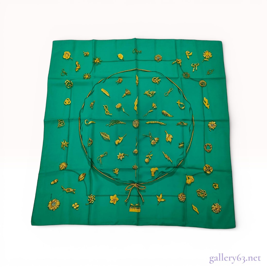 Hermes Silk Carre 90 Scarf, Clips Pattern: A vintage Hermes silk twill scarf featuring the Clips pattern designed by Vladimir Rybaltchenko, signed RYBAL. The design displays an array of gold jewelry illustrations including floral brooches, ear