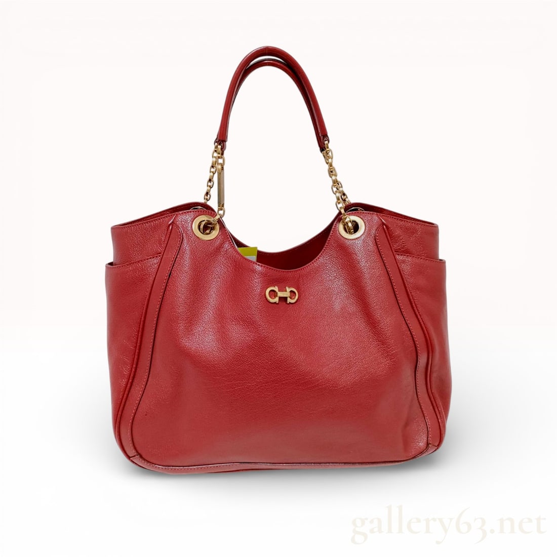 Salvatore Ferragamo Betulla Pebbled Leather Tote Bag, Red: This Salvatore Ferragamo Betulla tote is crafted from vibrant red pebbled leather, featuring the house's signature gold-tone Gancini logo on the front. The bag is designed for practicality and style,