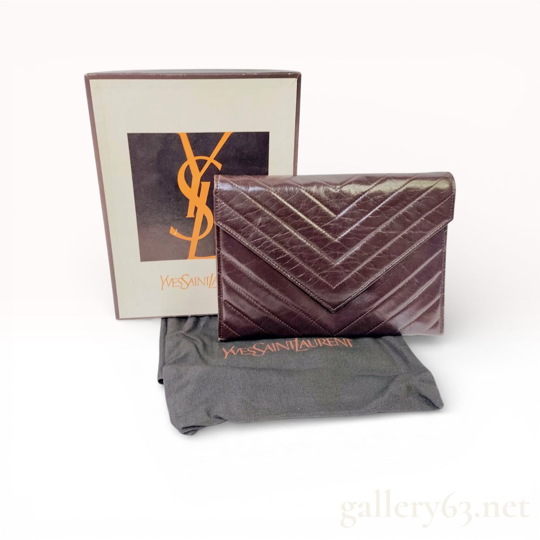 Yves Saint Laurent Vintage Chevron Quilted Leather Envelope Clutch, Dark Brown: This vintage Yves Saint Laurent envelope clutch is crafted from dark brown glazed leather featuring a classic chevron quilted pattern. The exterior design includes a V-shaped front flap with a conceal