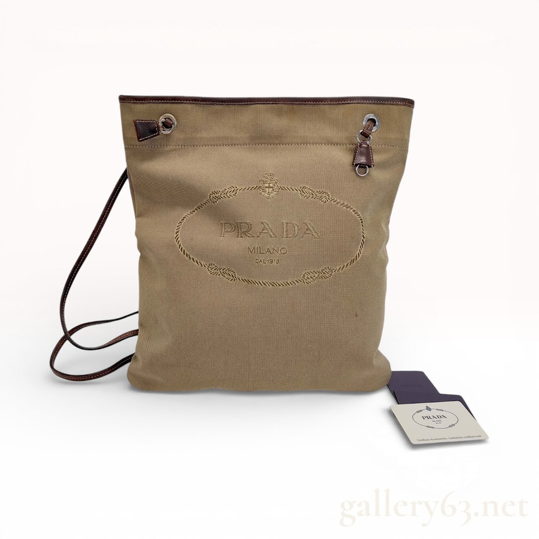 Prada Logo Jacquard Messenger Bag, Canvas and Leather, Khaki: This Prada messenger bag is crafted from durable khaki-colored jacquard-woven canvas featuring the signature house logo prominently on the front face. The design is accented with dark brown leather tr