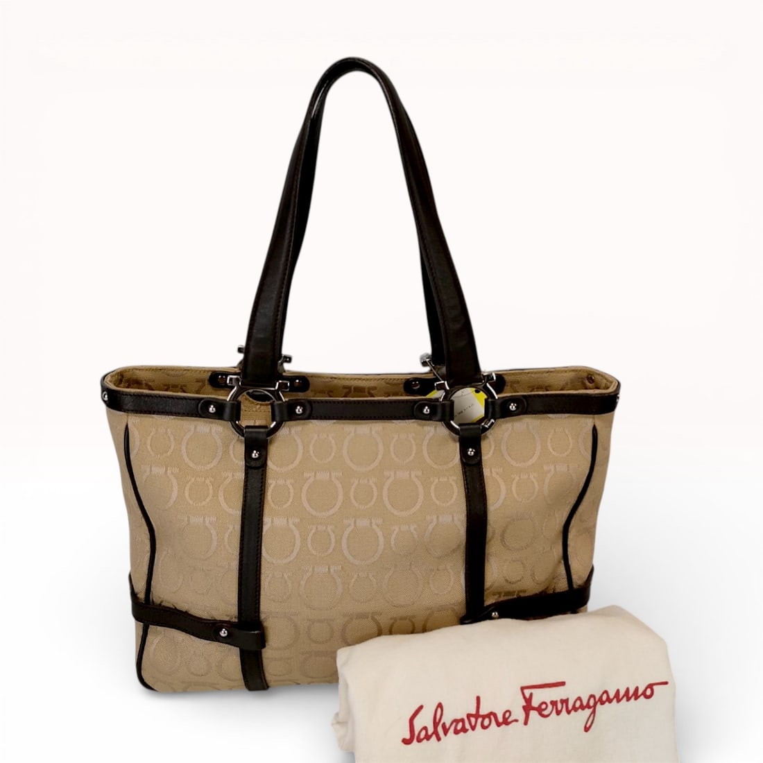 Salvatore Ferragamo Gancini Monogram Canvas and Leather Tote Bag, Beige and Brown: This Salvatore Ferragamo tote bag is crafted from beige jacquard canvas featuring the signature all-over Gancini monogram pattern. The design is accented with dark brown grained leather trim, base str