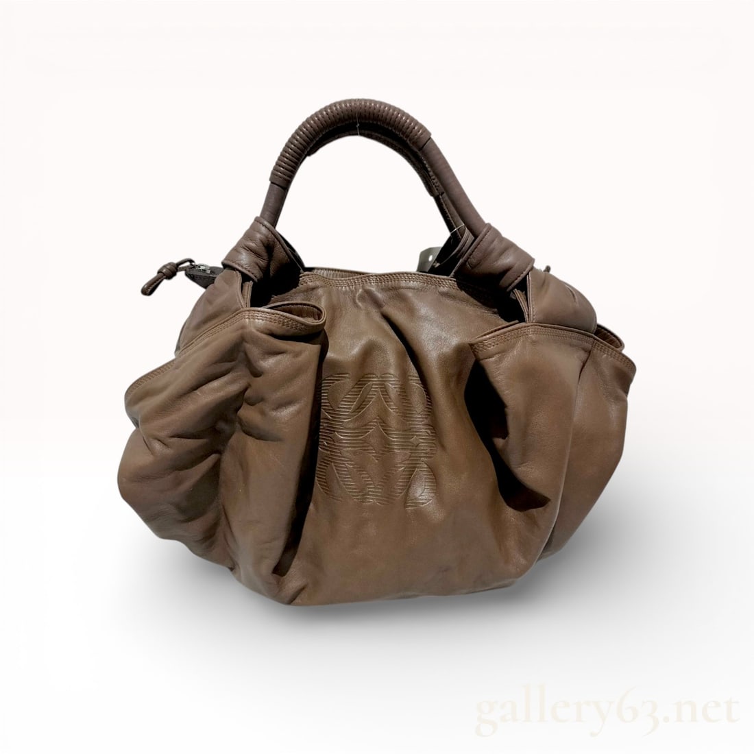 Loewe Nappa Aire Handbag in Brown Leather: This Loewe Aire handbag is crafted from exceptionally soft and supple nappa leather in a warm brown shade. The design features a relaxed, slouchy silhouette accented by intricate pleating and gathered