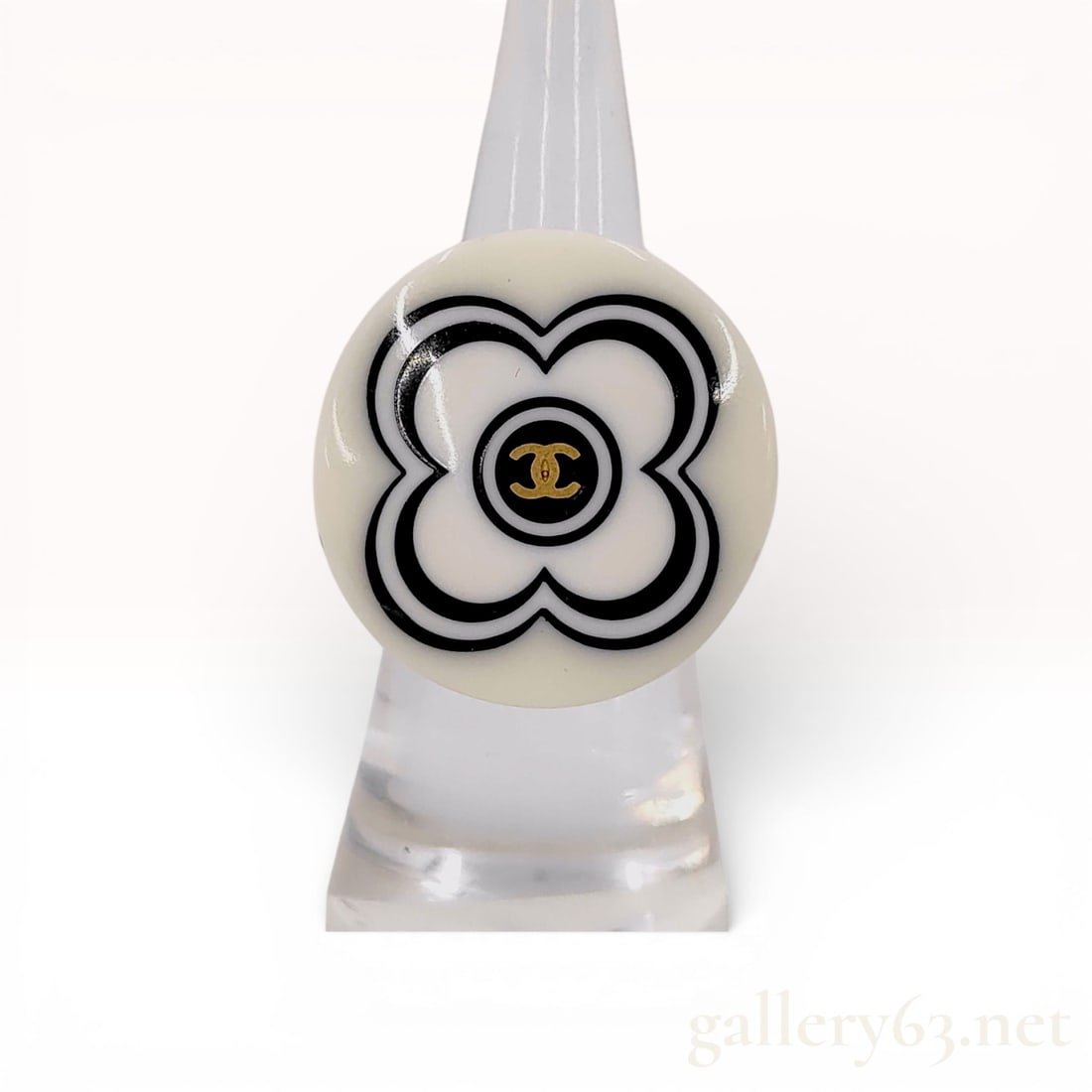 Chanel Resin Camellia Motif Cocktail Ring: This vintage Chanel cocktail ring is a notable piece from the Spring 2002 collection. The ring is constructed from a single piece of cream-colored resin with a chunky band and an integrated flat,