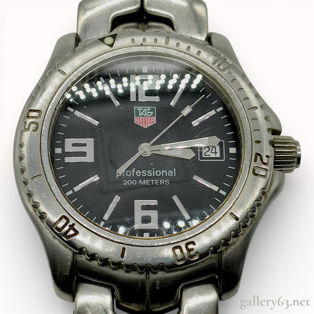 TAG Heuer Link Professional 200 Meters Stainless Steel Watch: TAG Heuer. Model: Link Professional 200 Meters. Reference: WT1110. Movement: Swiss quartz. Case: Stainless steel with a unidirectional rotating bezel and screw-down crown featuring the TAG Heuer logo.