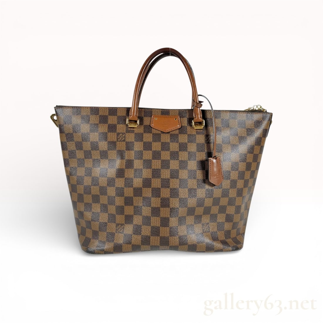 Louis Vuitton Belmont Tote Bag in Damier Ebene Canvas: This Louis Vuitton Belmont tote is crafted from signature Damier Ebene coated canvas with chocolate brown leather trim and dual rolled handles. The bag features polished gold-tone brass hardware,