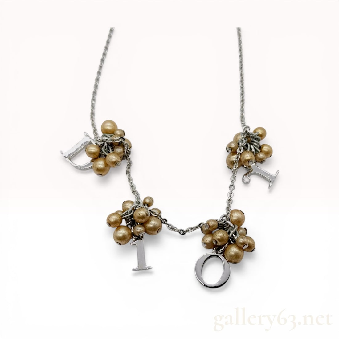 Christian Dior by John Galliano Logo Letter and Faux Pearl Charm Necklace: Christian Dior fashion charm necklace from the John Galliano era, featuring silver-tone metal and champagne-colored faux pearls. The fine cable link chain supports four decorative clusters of faux pea