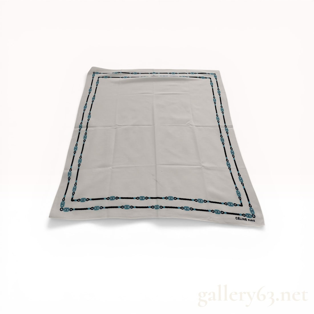 Celine Paris Cotton Blend Scarf with Triomphe Logo Border: Celine Paris scarf featuring a white ground and decorative border. The border design includes a navy rope motif intertwined with light blue chain links featuring the signature Triomphe logo. Construct