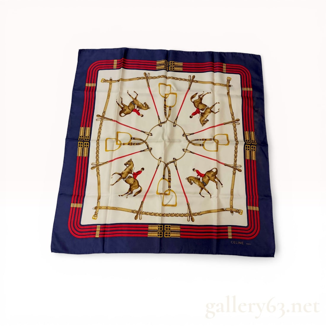Celine Paris Equestrian Jumping Pattern Silk Scarf: Celine Paris silk twill scarf in an equestrian Jumping pattern, late 20th century. The design features four riders in red hunt coats on a cream field with a border of riding crops, stirrups, and a nav