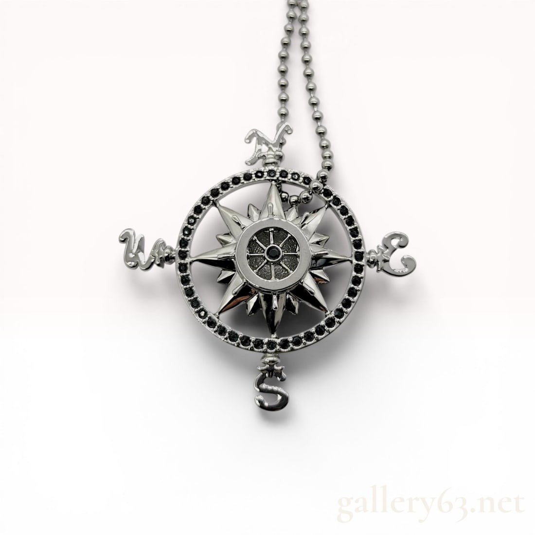 Swarovski for Disney Pirates of the Caribbean Compass Rose Pendant Necklace: Swarovski for Disney Pirates of the Caribbean compass rose pendant necklace. The silver-tone plated metal design features pavé-set black crystals on the outer rim and center, accented by a mult