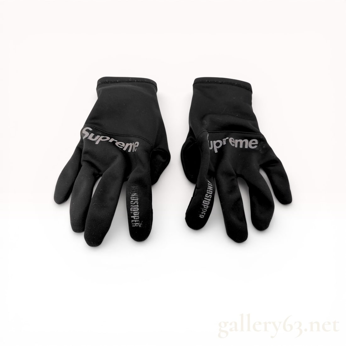 A Pair of Supreme WINDSTOPPER Gloves, Black: Supreme WINDSTOPPER performance gloves, Fall/Winter 2021. Crafted from 100% black polyester featuring wind-resistant technology and textured touchscreen-compatible pads on the thumbs and index fingers