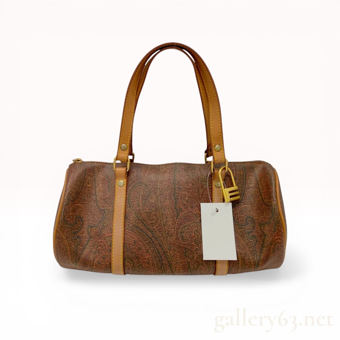 Etro Milano Classic Paisley Coated Canvas and Leather Barrel Bag: Vintage Etro barrel-shaped satchel featuring the signature multicolored paisley print on brown coated canvas. The bag is constructed with tan leather top handles, vertical support straps, and perimete