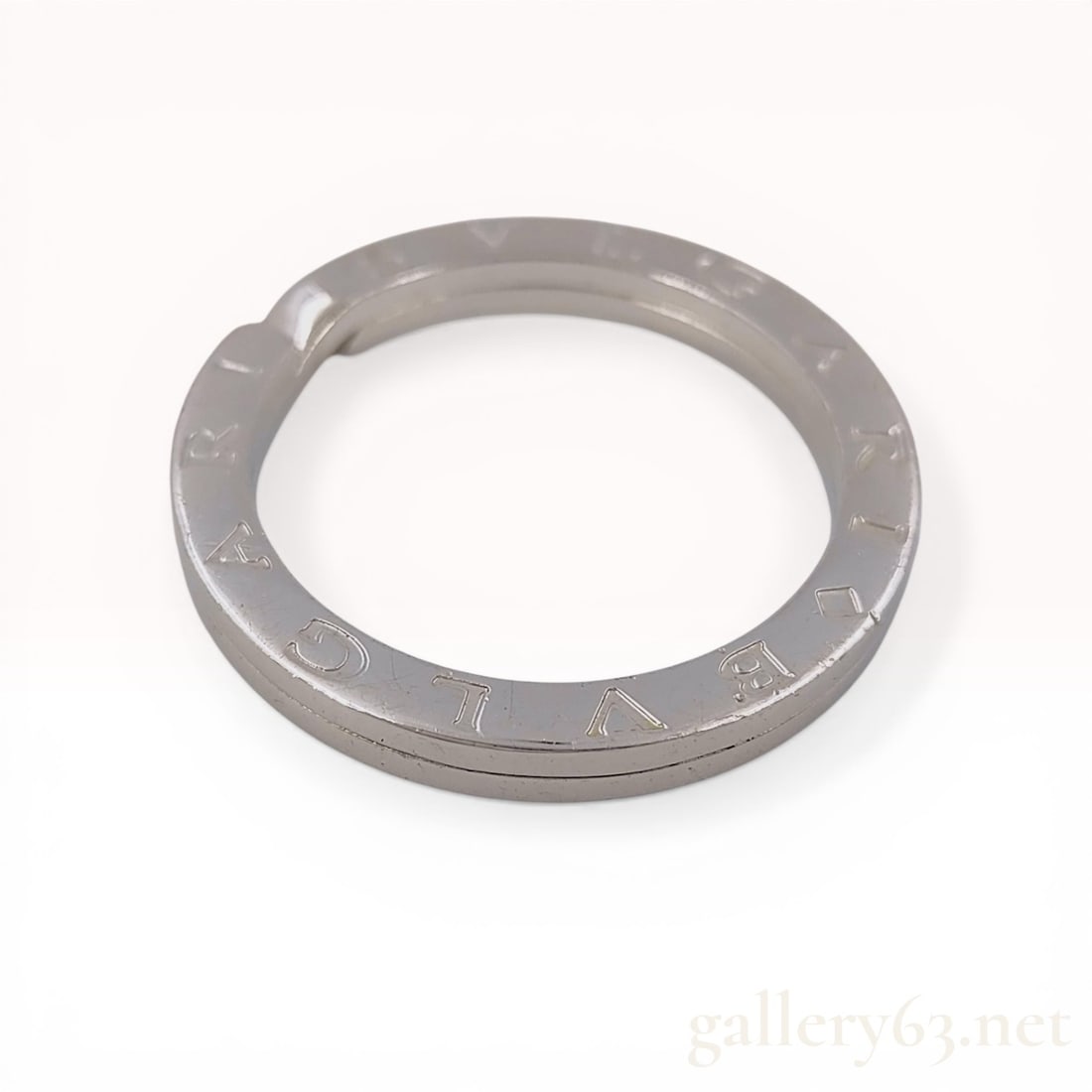 Bulgari Bvlgari Sterling Silver Key Ring: Bulgari Bvlgari key ring, contemporary. This circular split-ring is crafted from sterling silver and features a flat profile. The BVLGARI logo is stamped twice around the circumference of the flat sur