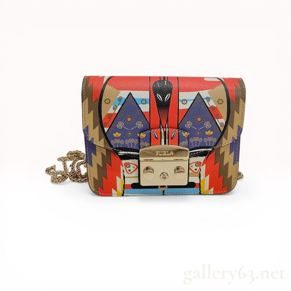 Furla Metropolis Mask Mini Crossbody Bag in Multicolor Textured Leather: Furla Metropolis mini crossbody bag featuring a vibrant multicolored geometric Mask print on textured Saffiano-style leather. The structured design includes a signature gold-tone engraved push-lock cl