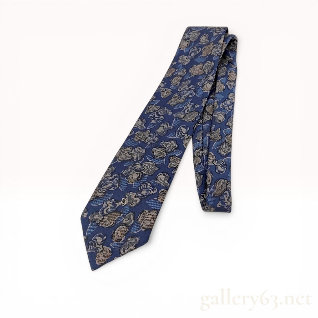 Christian Dior Monsieur Silk Jacquard Necktie: Christian Dior Monsieur men's necktie featuring an abstract floral jacquard weave. The 100 percent silk construction displays shades of grey and slate blue on a navy blue ground with an embroidered si