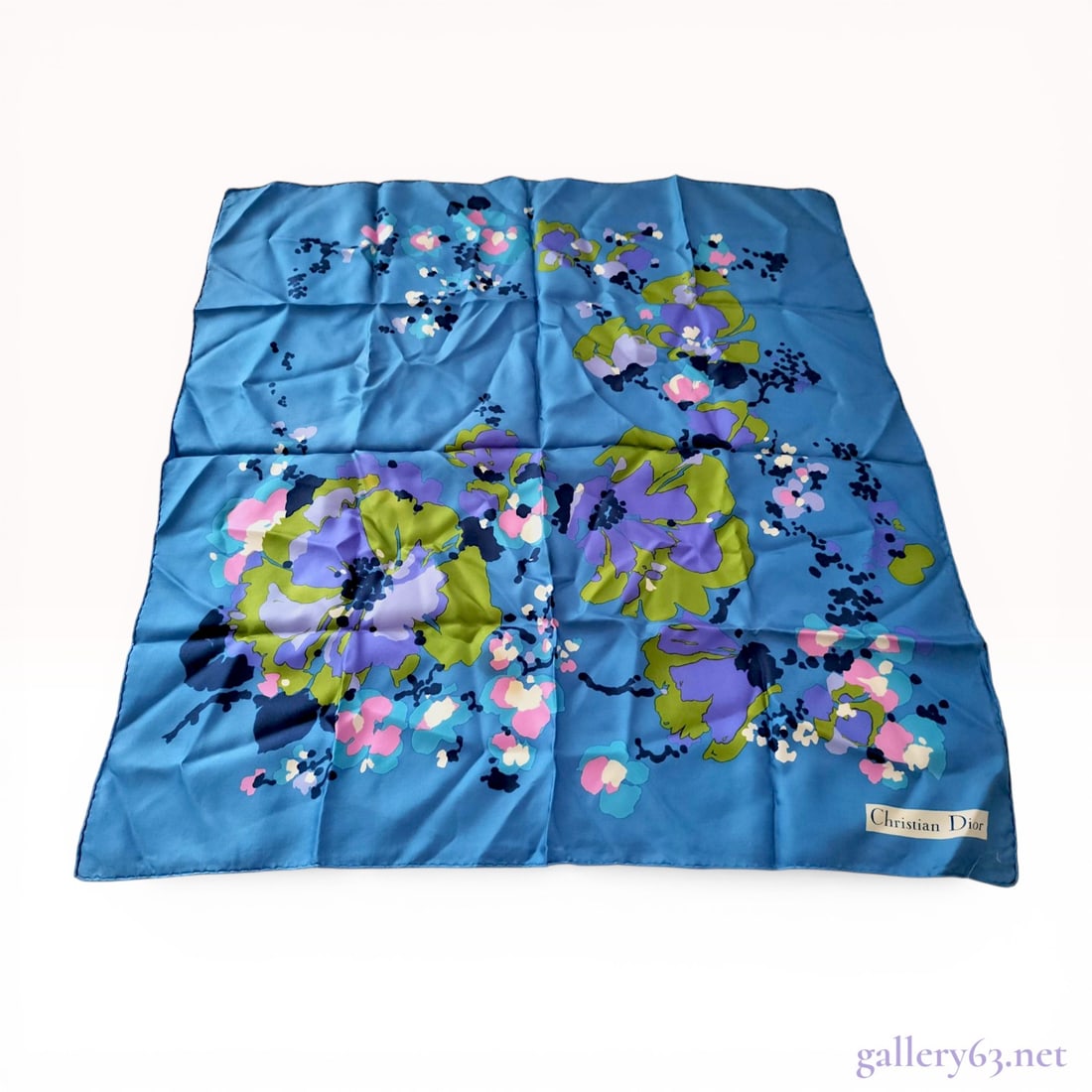 Christian Dior Vintage Silk Floral Square Scarf: Christian Dior vintage square scarf featuring a large-scale abstract floral pattern. The design is rendered in shades of purple, lime green, pink, and navy blue on a medium blue silk twill ground. Thi