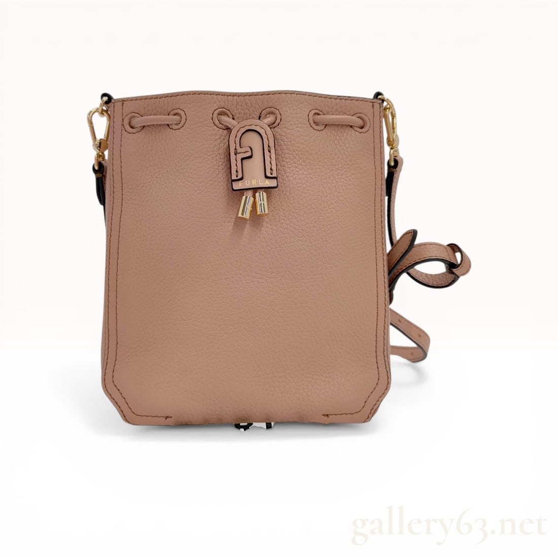Furla Atena Mini Grained Leather Crossbody Bucket Bag: Furla Atena mini bucket bag in nude grained pebbled leather with gold-tone hardware. This design features a drawstring closure with a signature Arch logo tab and includes an adjustable, detachable