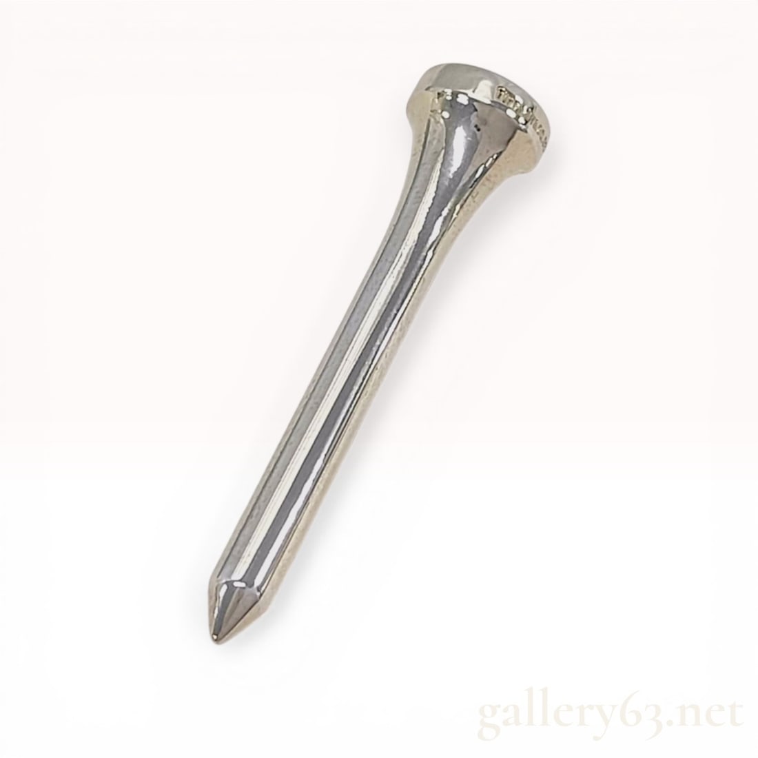 Tiffany & Co. Sterling Silver Golf Tee: Tiffany & Co. sterling silver golf tee, late 20th century. Traditional form with a flared concave head and tapering shank, constructed from solid .925 sterling silver. The side of the head is