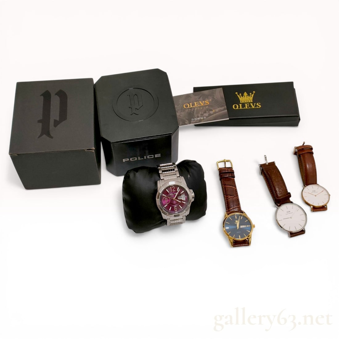 A Collection of Four Wristwatches by Police, Olevs, and Daniel Wellington: This collection of four contemporary wristwatches includes pieces from Police, Olevs, and Daniel Wellington. The Police gent's wristwatch features a stainless steel case and an integrated link