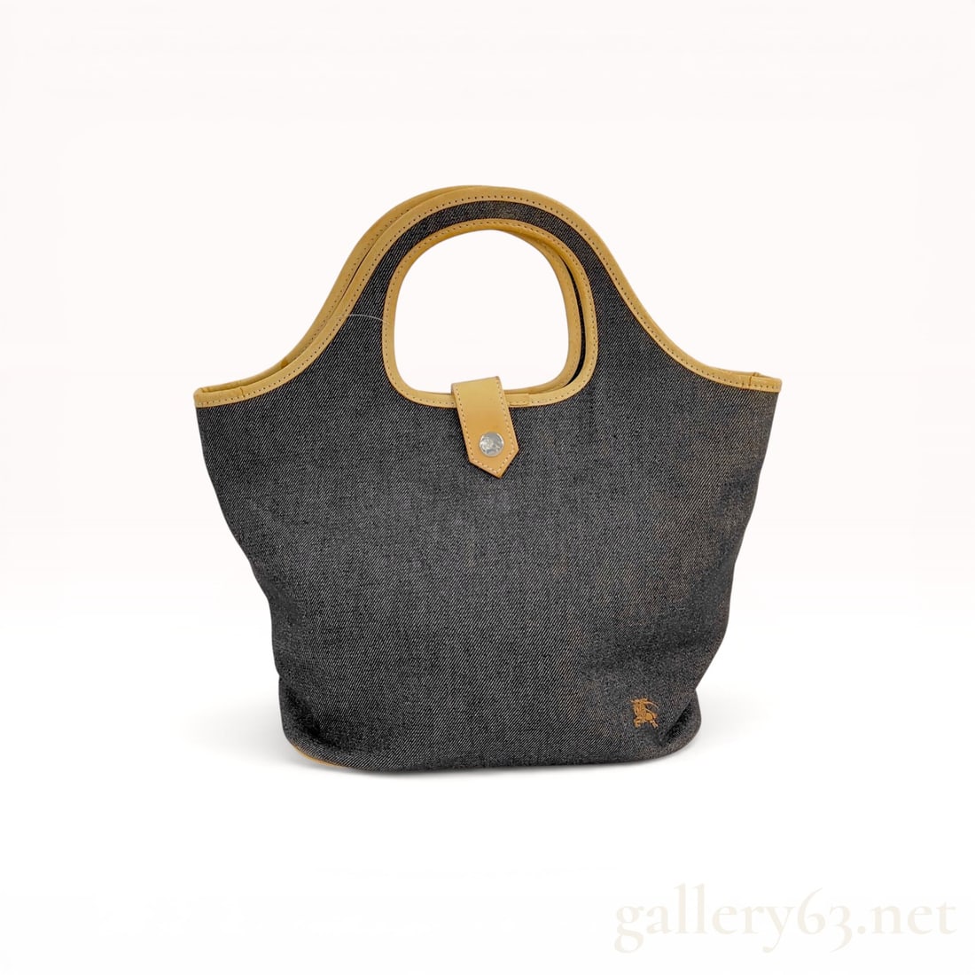 Burberry Blue Label Denim Small Tote Bag: Burberry Blue Label denim small tote bag featuring a dark gray denim body with tan leather trim and integrated circular handles. The exterior is detailed with an embroidered knight logo and a