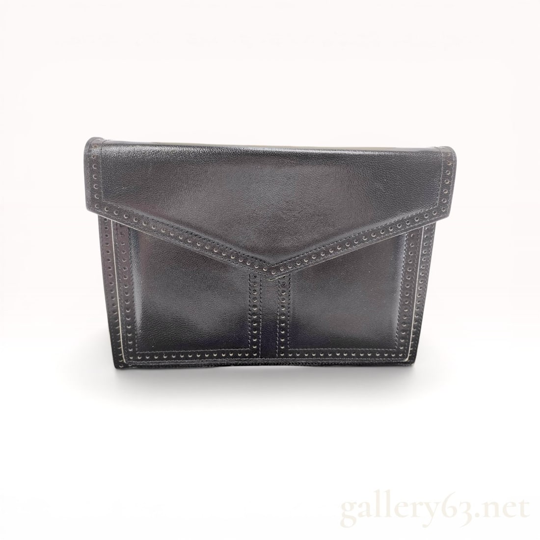 Vintage Yves Saint Laurent Black Textured Leather Envelope Clutch with Red Interior: Vintage Yves Saint Laurent envelope-style clutch bag in black textured leather, late 20th century. Comes with box & dust bag. The exterior features a pointed front flap with decorative perforated
