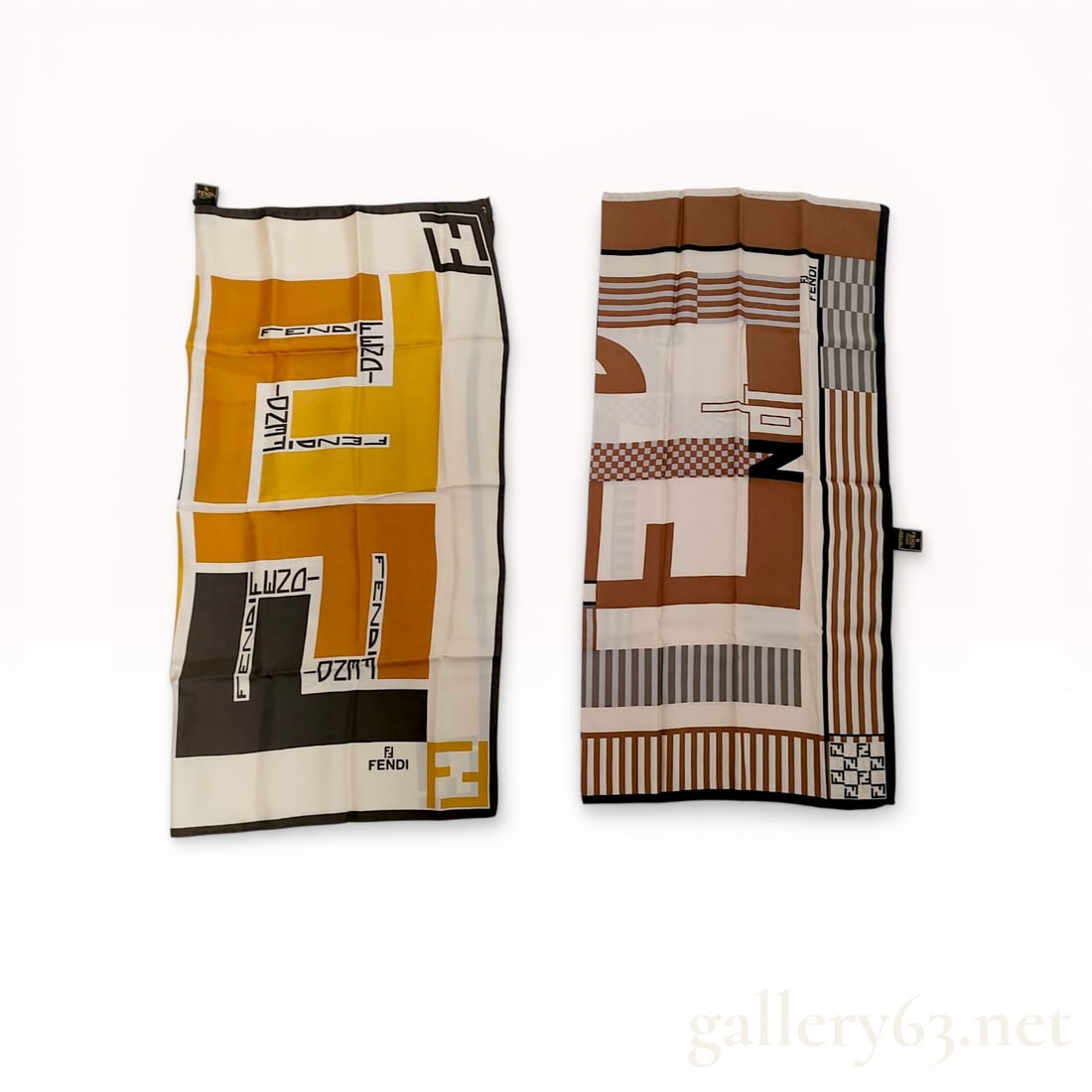 A Pair of Fendi Silk Foulard Scarves: Fendi, two square silk foulard scarves, late 20th century. One scarf features a bold geometric color-block design in ochre and black, while the other displays an abstract composition of stylized brand