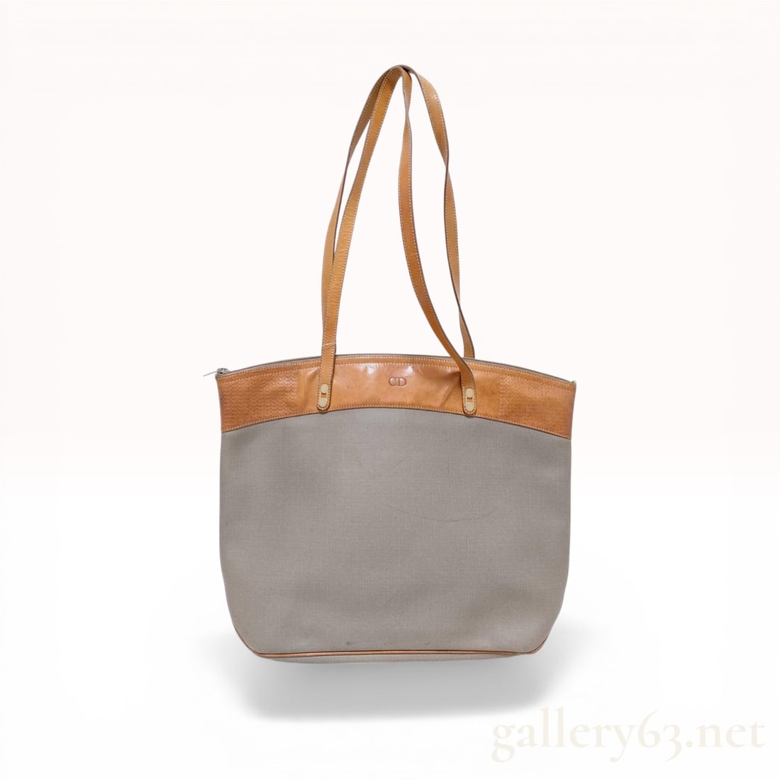 Christian Dior Vintage Grey Canvas and Tan Leather Shoulder Tote Bag: Christian Dior vintage shoulder tote bag, manufactured in France. The bag features a grey canvas body with tan leather trim, base piping, and dual shoulder straps. The exterior is detailed with an emb