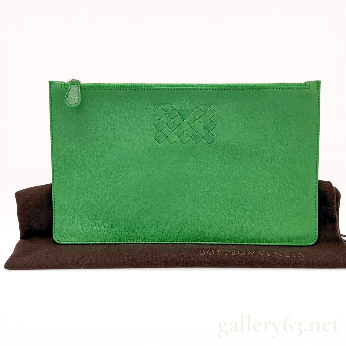 Bottega Veneta Parakeet Nappa Leather Small Turn Pouch: Bottega Veneta small turn pouch in Parakeet green nappa leather, contemporary. The rectangular body features a central embossed intrecciato motif, a top zip closure with gold-tone hardware, and an inc