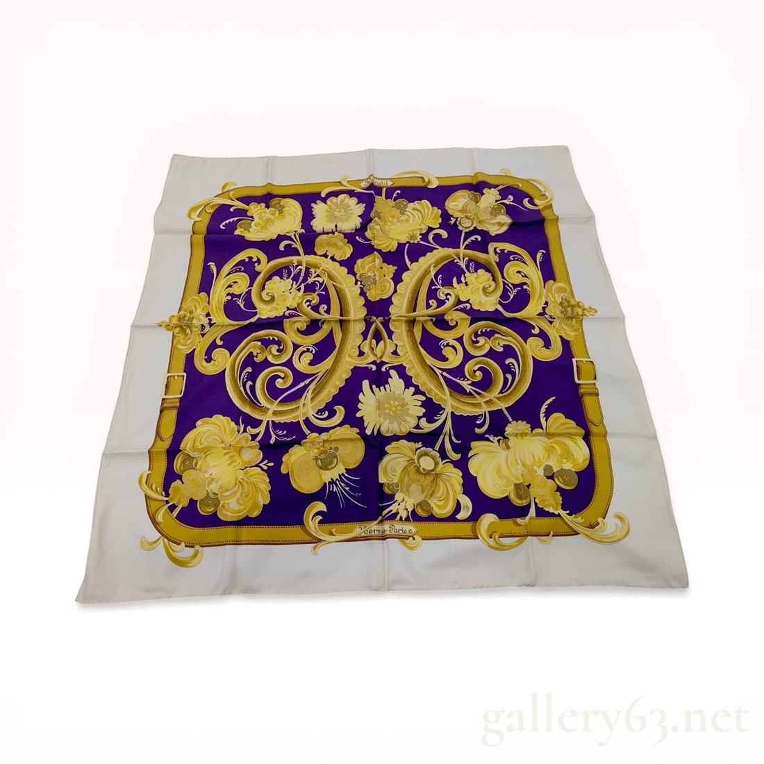Hermes Harald Silk Carre 90: Hermes silk scarf in the Harald pattern designed by Caty Latham. The design features a purple field with golden yellow acanthus scrolls and floral motifs surrounded by a buckle-motif border and cream