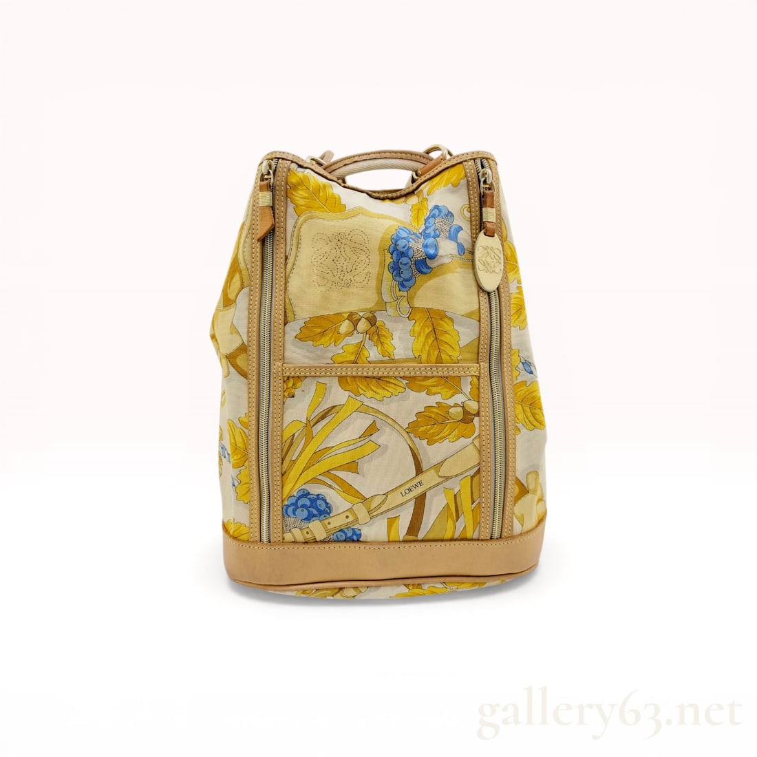 Loewe Vintage Printed Canvas and Leather Backpack: Vintage Loewe backpack featuring a cream canvas body with an all-over botanical and belt motif print. The bag is constructed with natural tan leather trim, a reinforced base, and adjustable rope and l