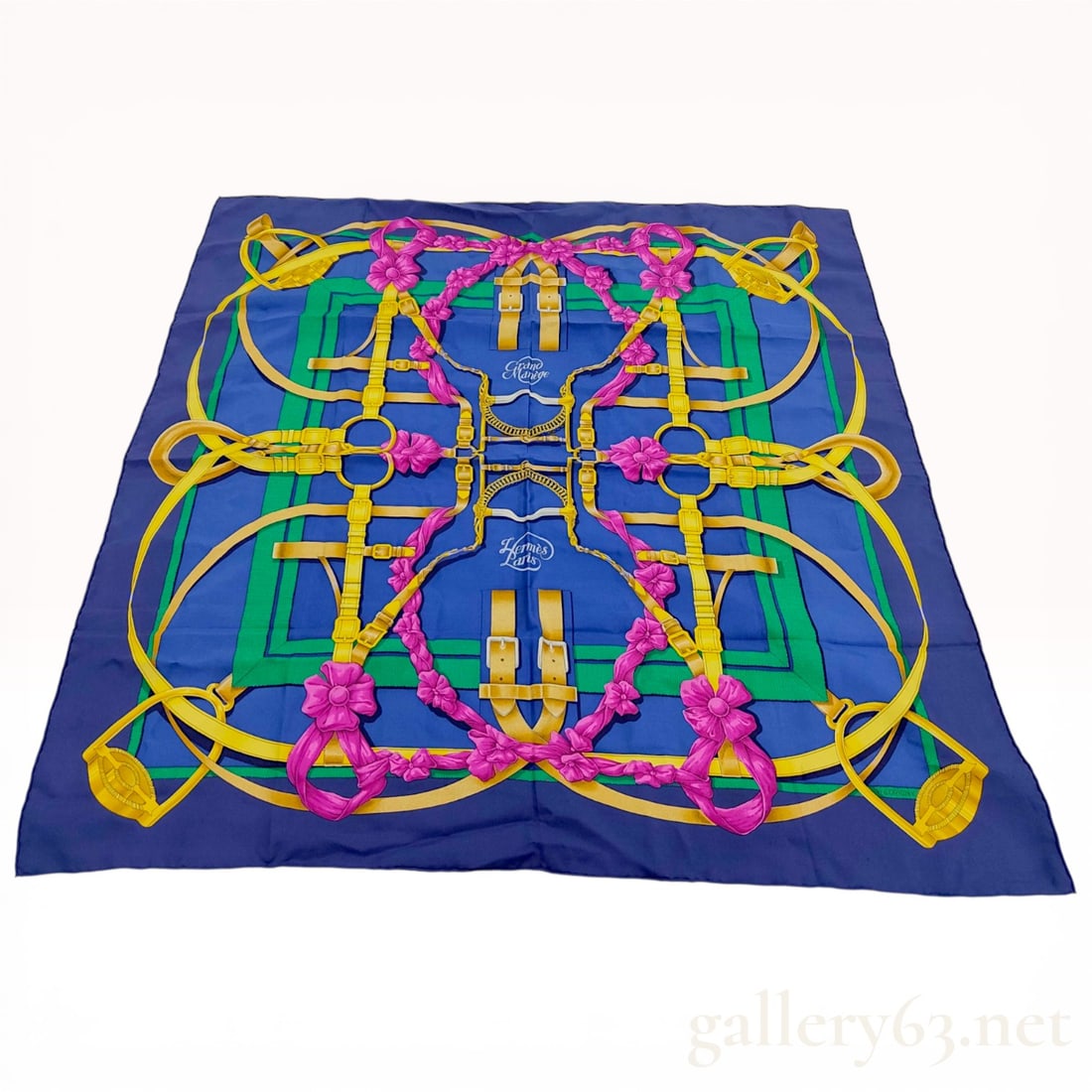 Herm?¨s Grand Man?¨ge Silk Scarf by Henri d'Origny: Hermès silk scarf in the Grand Manège pattern designed by Henri d'Origny. The design features a symmetrical equestrian motif with golden-yellow bridles and magenta floral rosettes on a r