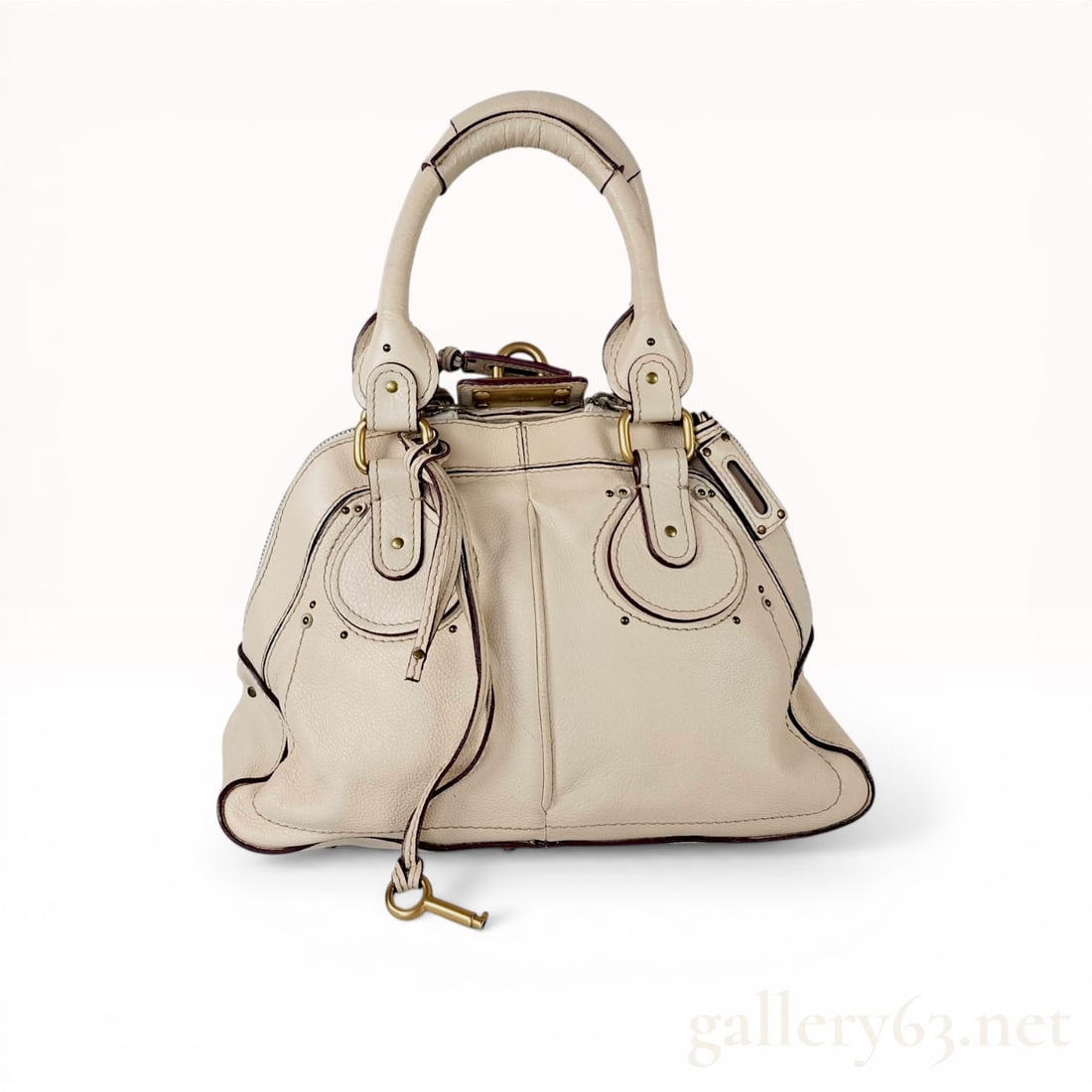 Chloe Paddington Leather Satchel: Chloe Paddington satchel in off-white pebbled leather with dark burgundy edge glazing. The design features dual rolled handles, signature C shaped leather patches with stud accents, and antiqued brass