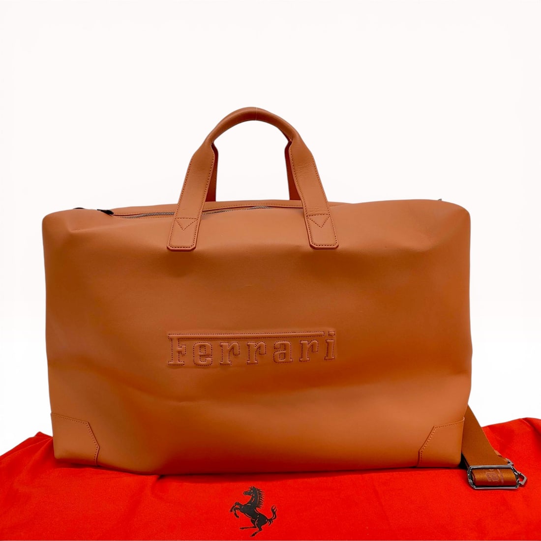 Ferrari 12Cilindri Limited Owners Edition Leather Duffle Bag: Ferrari 12Cilindri Limited Owners Edition duffle bag, 21st century. Crafted from smooth cognac calfskin leather with gunmetal-tone hardware and a black textile-lined interior. Features dual rolled top