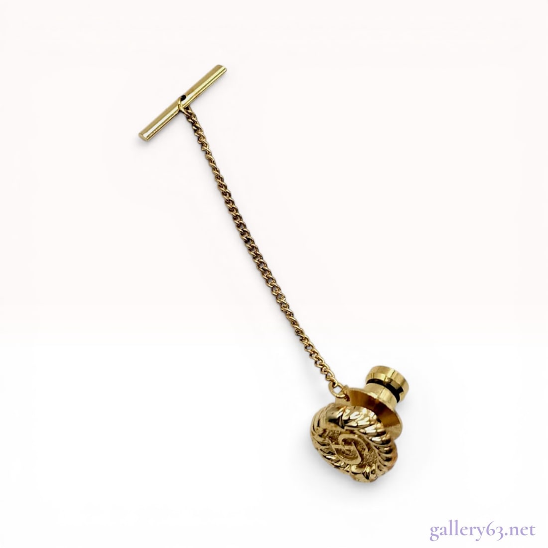 Christian Dior Monsieur Gold-Tone Logo Tie Tack with Safety Chain: Christian Dior Monsieur tie tack, 20th century. The circular gold-tone face features a textured rope-twist border and a stippled central medallion with an interlaced CD logo. Construction includes a p