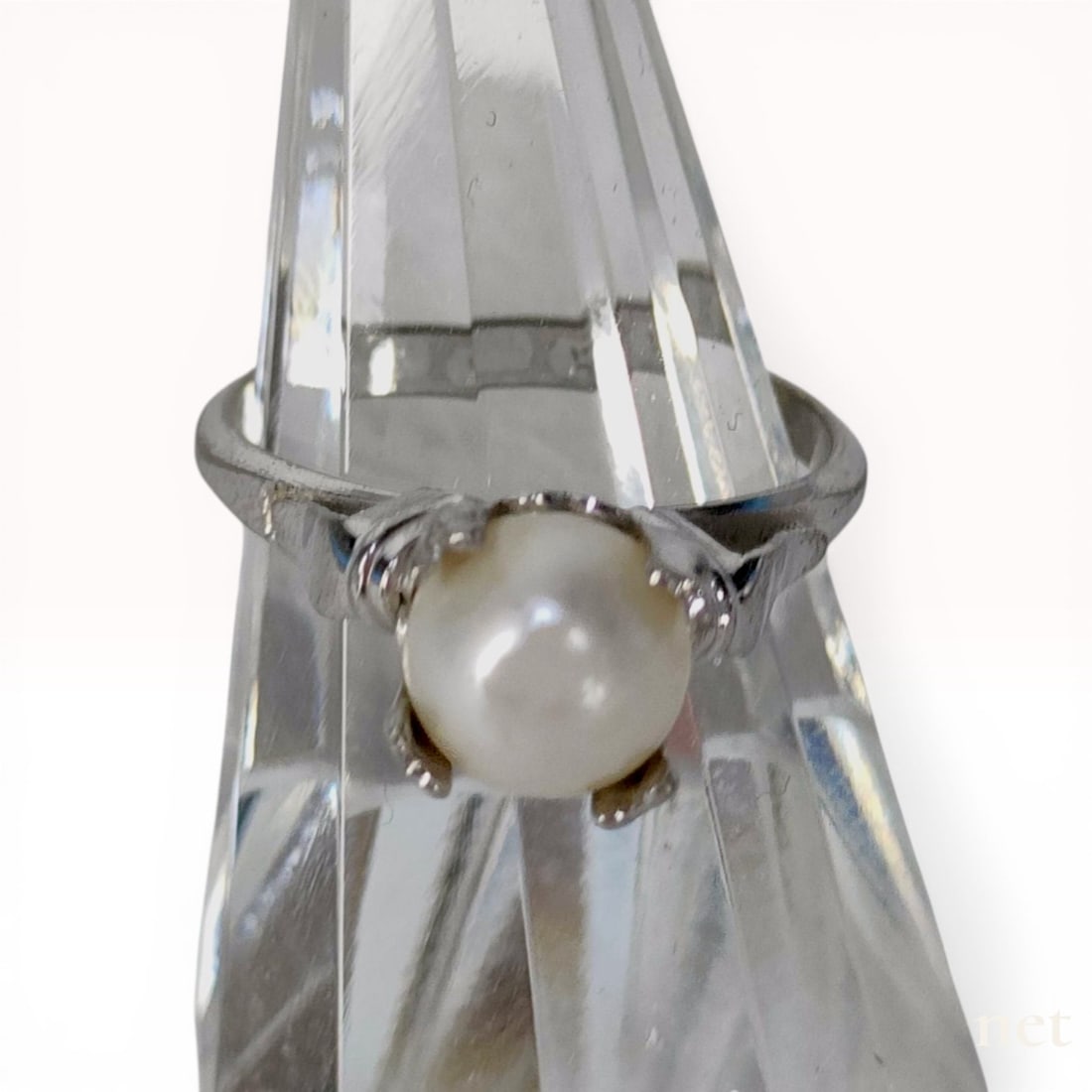 Solitaire Cultured Pearl Ring in Sterling Silver: Vintage-style solitaire ring featuring a single round cream-white cultured pearl. The central pearl is secured in a multi-prong basket setting accented by decorative ribbed shoulders. The interior of