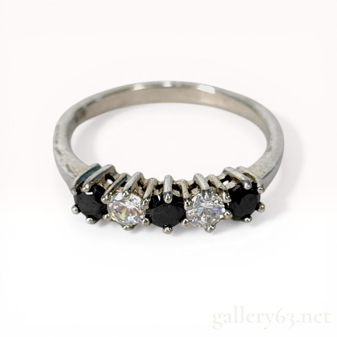 C-Angle Sterling Silver Five-Stone Spinel and Transparent Stone Anniversary Band: C-Angle five-stone anniversary-style ring in sterling silver. The band features three round-cut black spinels alternating with two clear transparent stones in four-prong settings. The interior of the
