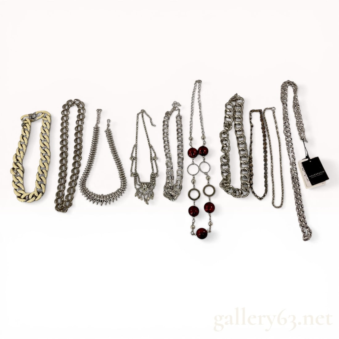 An Assortment of Nine Designer and Fashion Costume Necklaces Including Adolfo Dominguez and: This collection features nine fashion necklaces in various styles, including an Adolfo Dominguez cream enamel curb-link choker and a Novespazio textured long link chain. The assortment includes a rhin