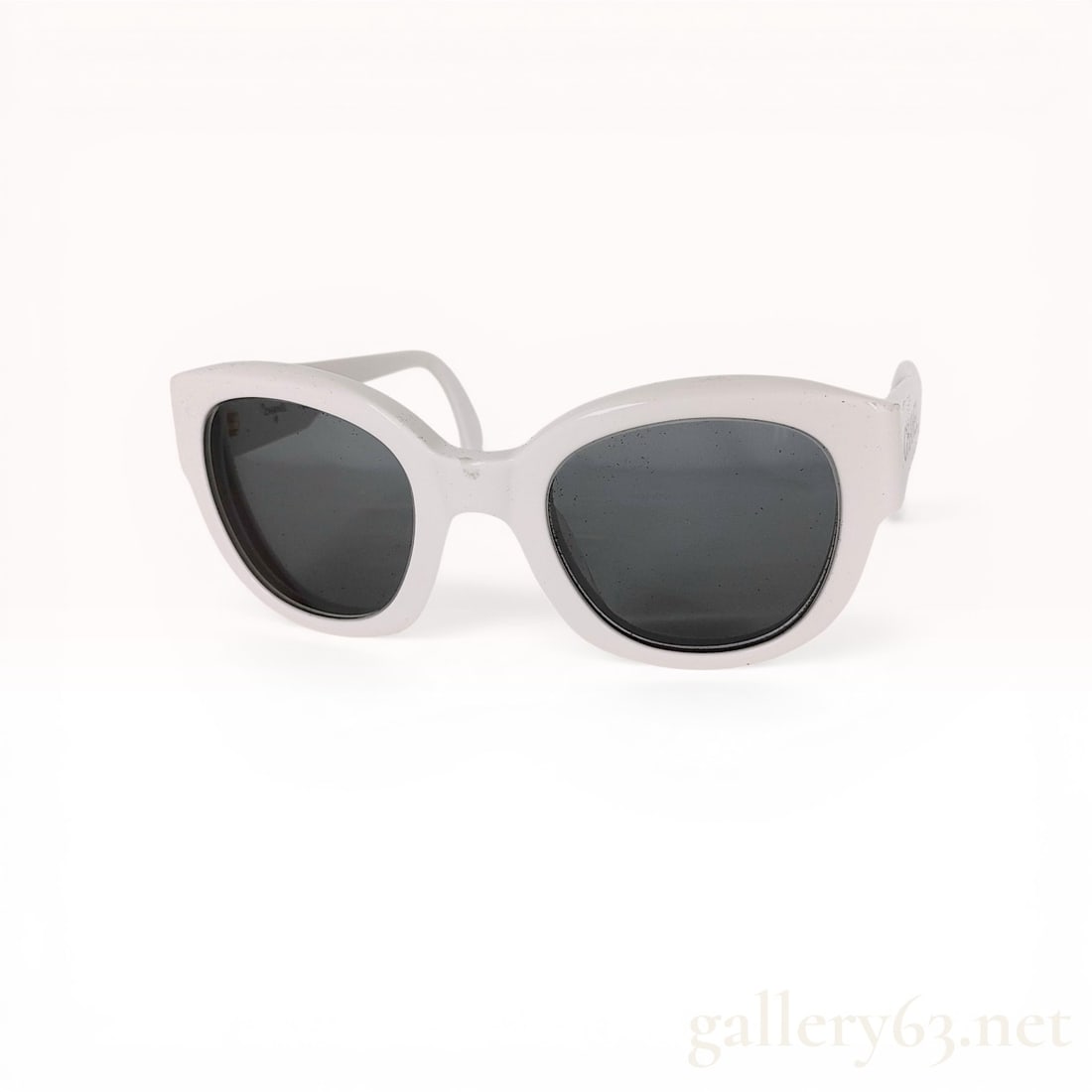 Chanel White Acetate Logo Sunglasses: Chanel white acetate sunglasses, late 20th century. Rectangular upswept frames featuring wide temples with bold black CHANEL block lettering and dark tinted lenses. Interior right temple marked with c