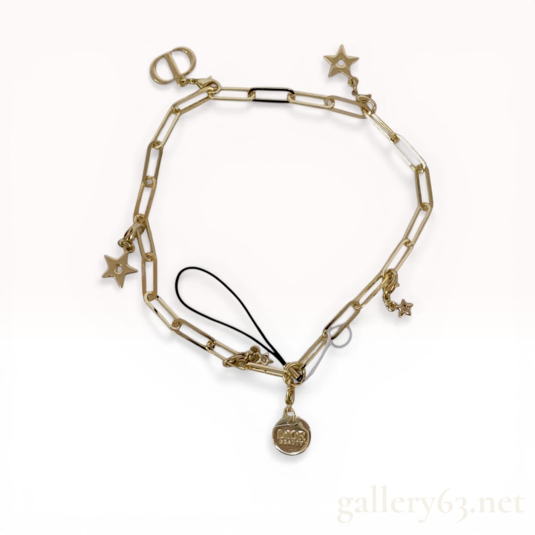 Dior Beauty Gold-Tone Star and Logo Charm Phone Strap and Bracelet: Dior Beauty contemporary multi-functional charm chain, 21st century. The gold-tone base metal paperclip link chain features a black textile cord loop, four open-center star charms of varying sizes, an