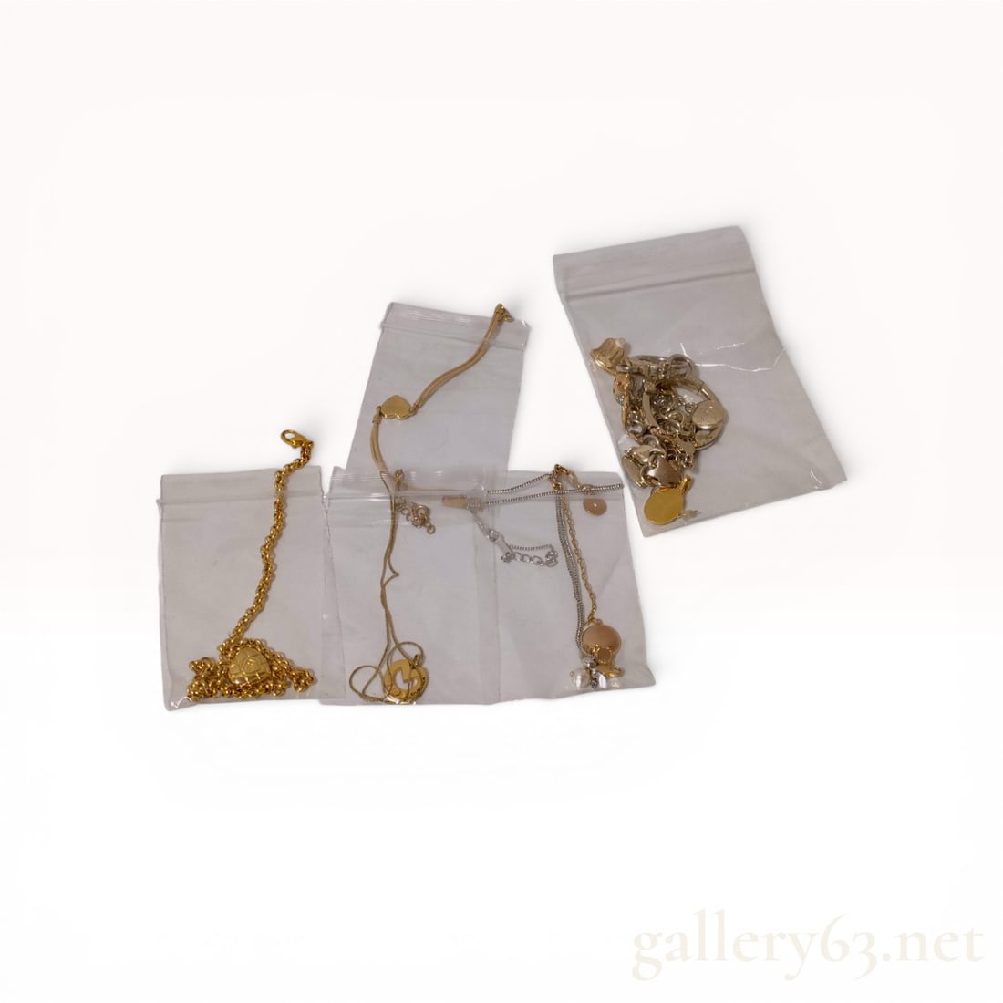 A Collection of Marc Jacobs and Fashion Jewelry Necklaces, Charms, and Earrings: This collection features a Marc Jacobs charm assembly and various fashion jewelry necklaces and earrings. The items are constructed from gold-tone and silver-tone base metals with synthetic crystal, e