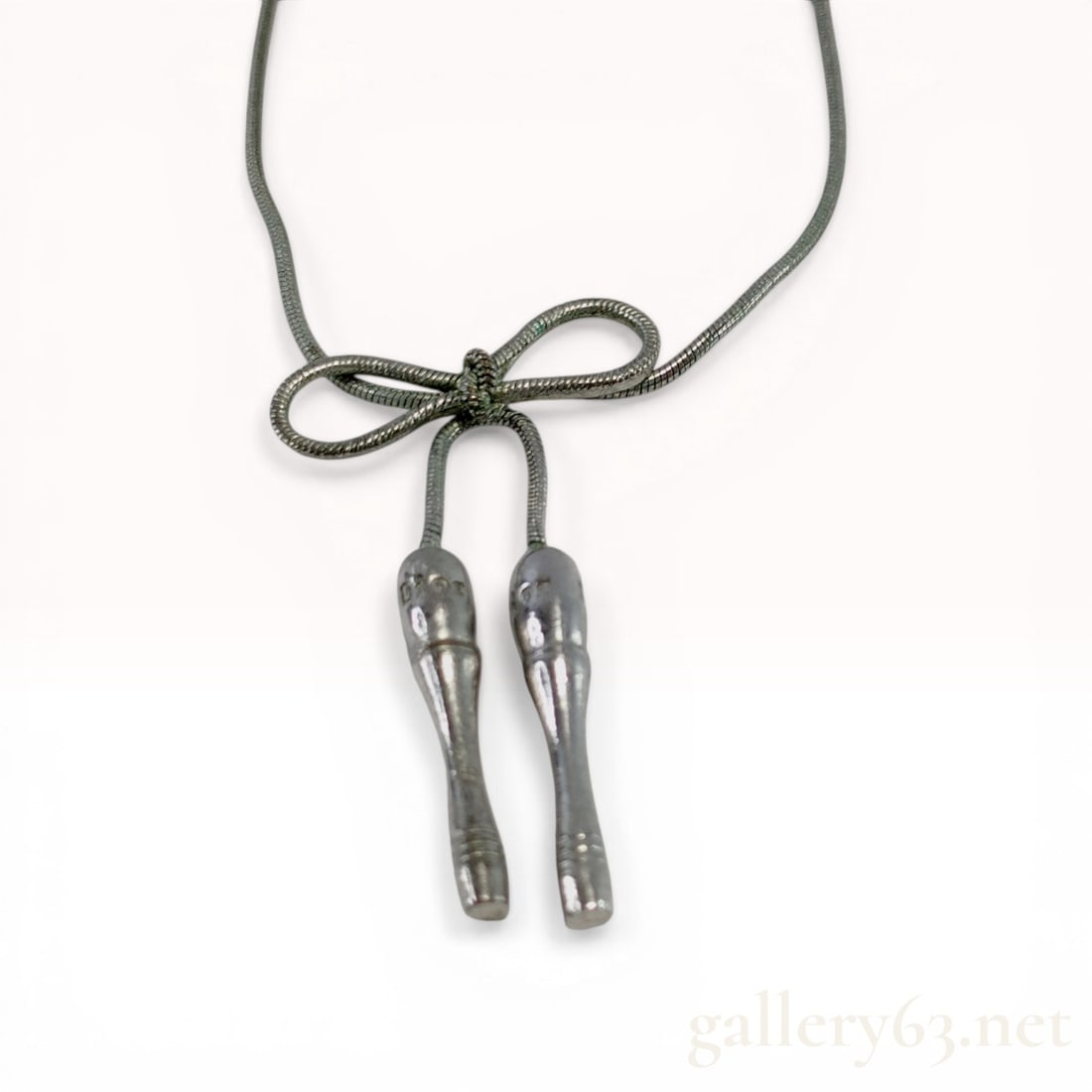 Christian Dior Silver-Tone Lariat Bow Choker Necklace: Christian Dior lariat-style choker necklace, late 20th century. Silver-tone base metal snake chain featuring a fixed bow slider and two dangling club-shaped finials. The piece secures with a D-shaped