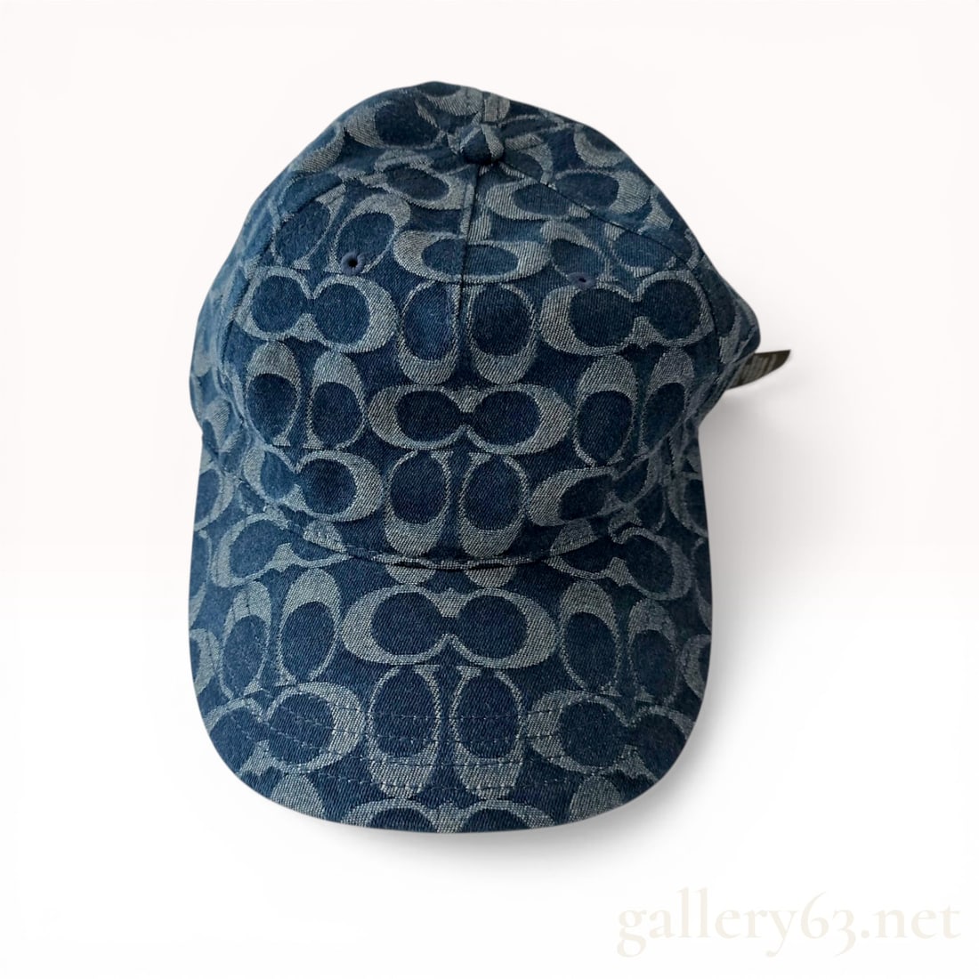 Coach Signature Denim Baseball Hat: Coach Signature denim baseball hat, style CZ925. This six-panel cap is constructed from 100% cotton featuring an allover blue signature jacquard pattern, ventilation eyelets, and a curved brim. The ba