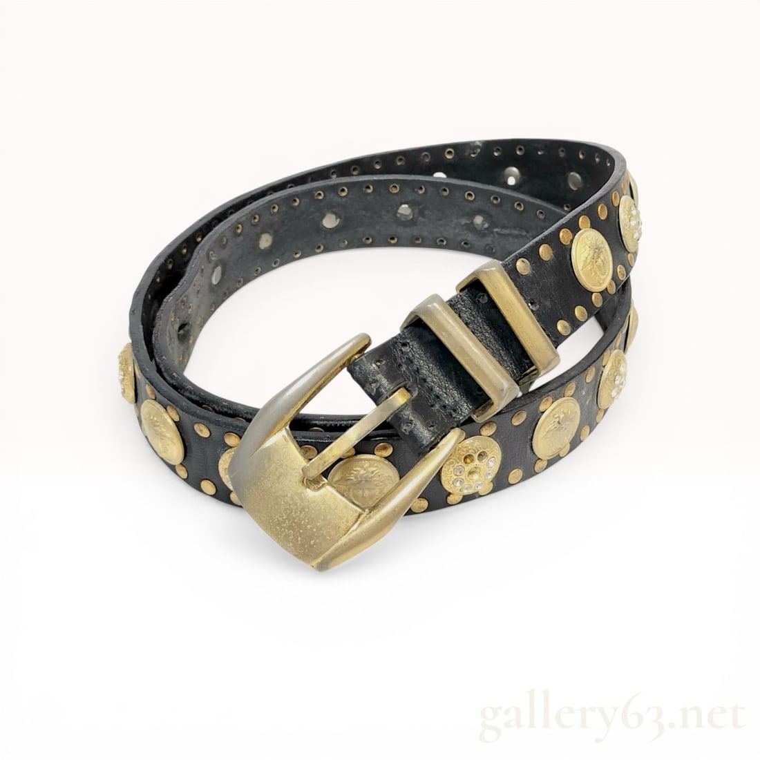 Vintage Gianni Versace Medusa Ornamented Leather Belt: Gianni Versace ornamented leather belt, late 20th century. The black leather strap is decorated with two rows of gold-tone studs, Medusa-head medallions, and openwork floral medallions set with clear
