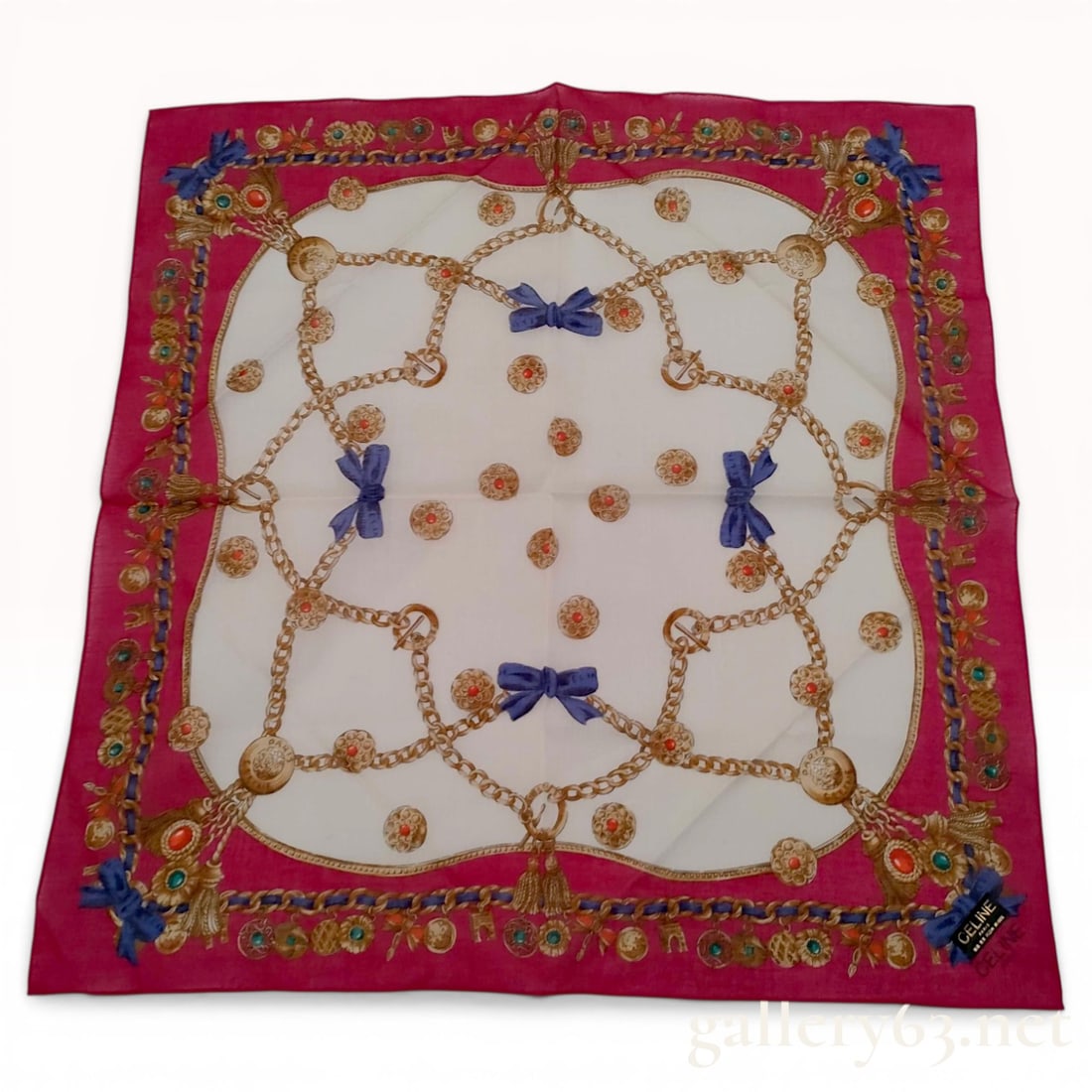Celine Paris Cotton Jewel and Chain Motif Handkerchief: Celine Paris square handkerchief featuring an ornate jewel and chain motif. The design incorporates gold chains, tassels, and cabochon charms in emerald green and coral red set against a white field a