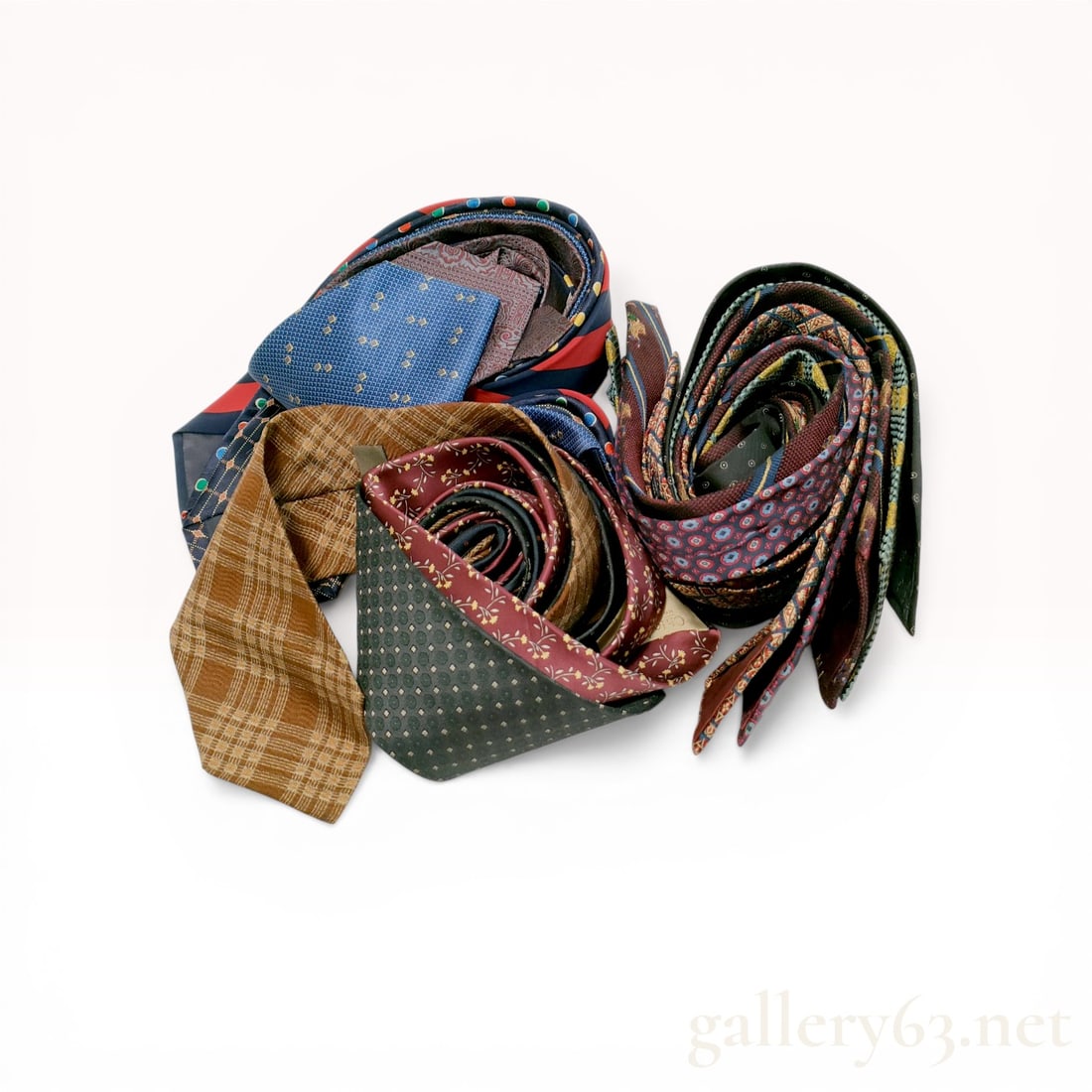 An Assortment of Designer Silk Neckties Including Chloe Homme and Calvin Klein: A collection of men's silk neckties featuring various luxury designers such as Chloe Homme, Calvin Klein, Versace, Dior, Yves Saint Laurent, and Comme des Garcons. The group includes a diverse range o