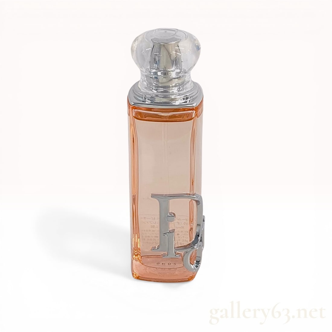 Christian Dior Dior Addict Peachy Glow Eau de Parfum with Original Box: Christian Dior Dior Addict Peachy Glow eau de parfum, circa 2005. The 30 ml (1 fl. oz.) rectangular glass bottle contains a peach-colored fragrance and features a silver-toned Di logo, a spherical cle