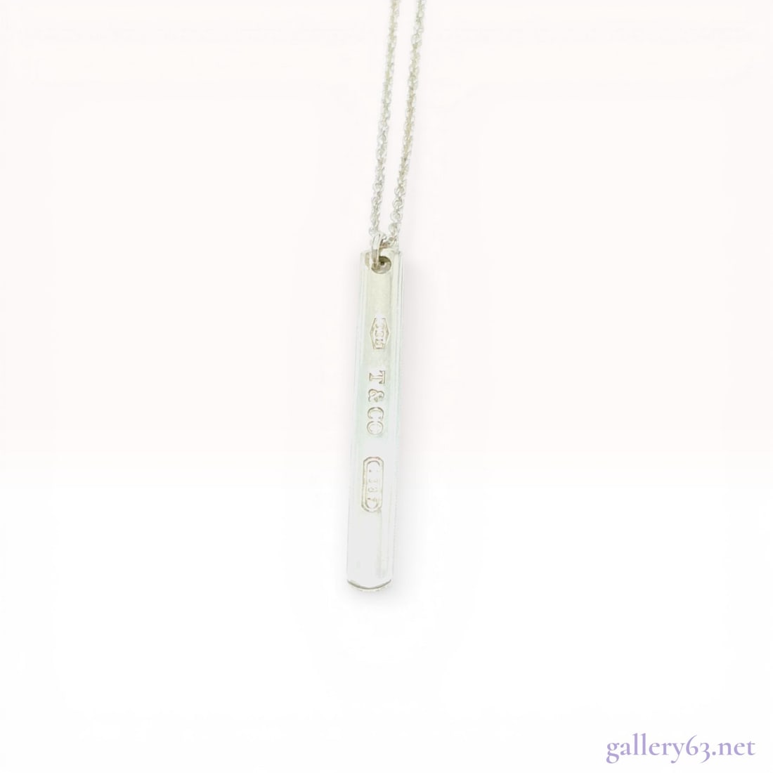 Tiffany and Co. 1837 Sterling Silver Bar Pendant Necklace: Tiffany and Co. sterling silver bar pendant necklace from the 1837 collection. The vertical bar pendant features a concave surface and is suspended from a fine cable chain with a spring ring clasp. Ha