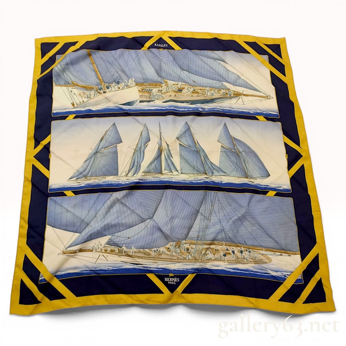 Herm?¨s Rafales Silk Twill Scarf: Hermès silk twill scarf in the Rafales pattern, designed by Yannick Manier. The nautical composition features three horizontal panels depicting racing yachts with blue sails, framed by a navy b